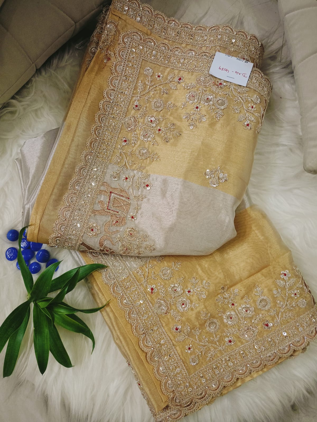 Gold Tissue Saree Featuring Intricate Hand Embellishment